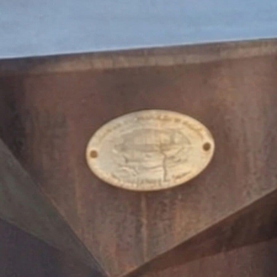 Oval brass plaque on the corten surface of the fire bowl
